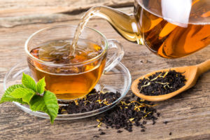 Tea composition with mint leaf on wooden palette